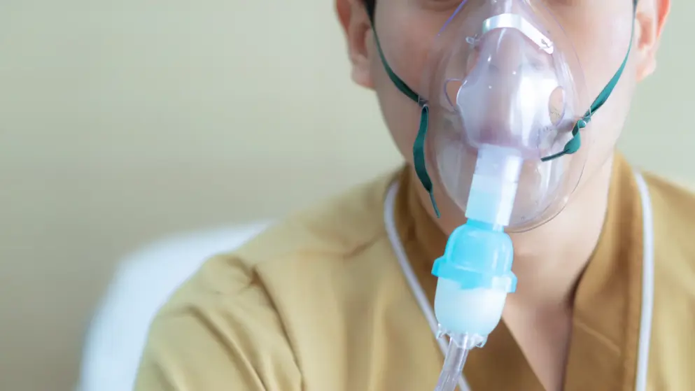 Young boy with cystic fibrosis, oxygen mask on his face