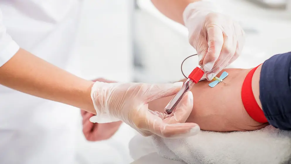 A blood draw being performed on the inside of a person's arm; testing for hyperkalaemia