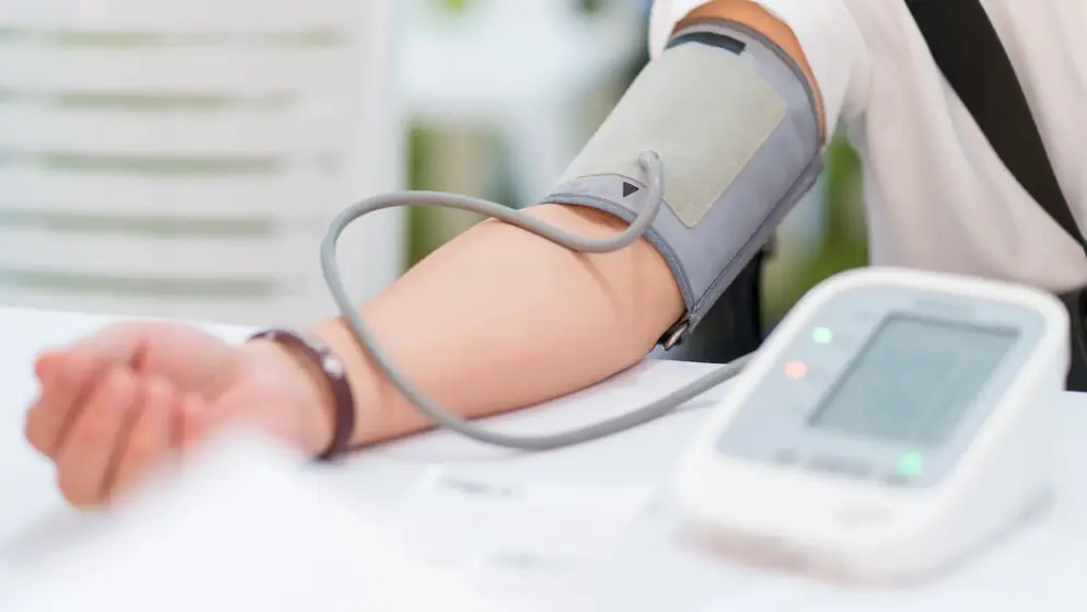 An arm with a blood pressure gauge attached; testing for high blood pressure