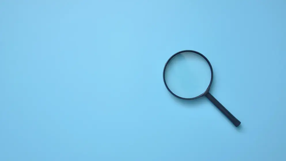 Magnifying glass on blue background; searching for results